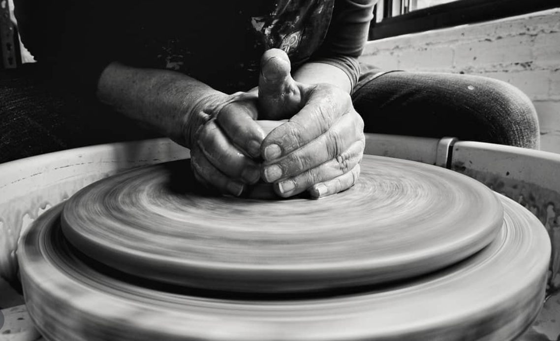 Pauline shaping clay in her studio